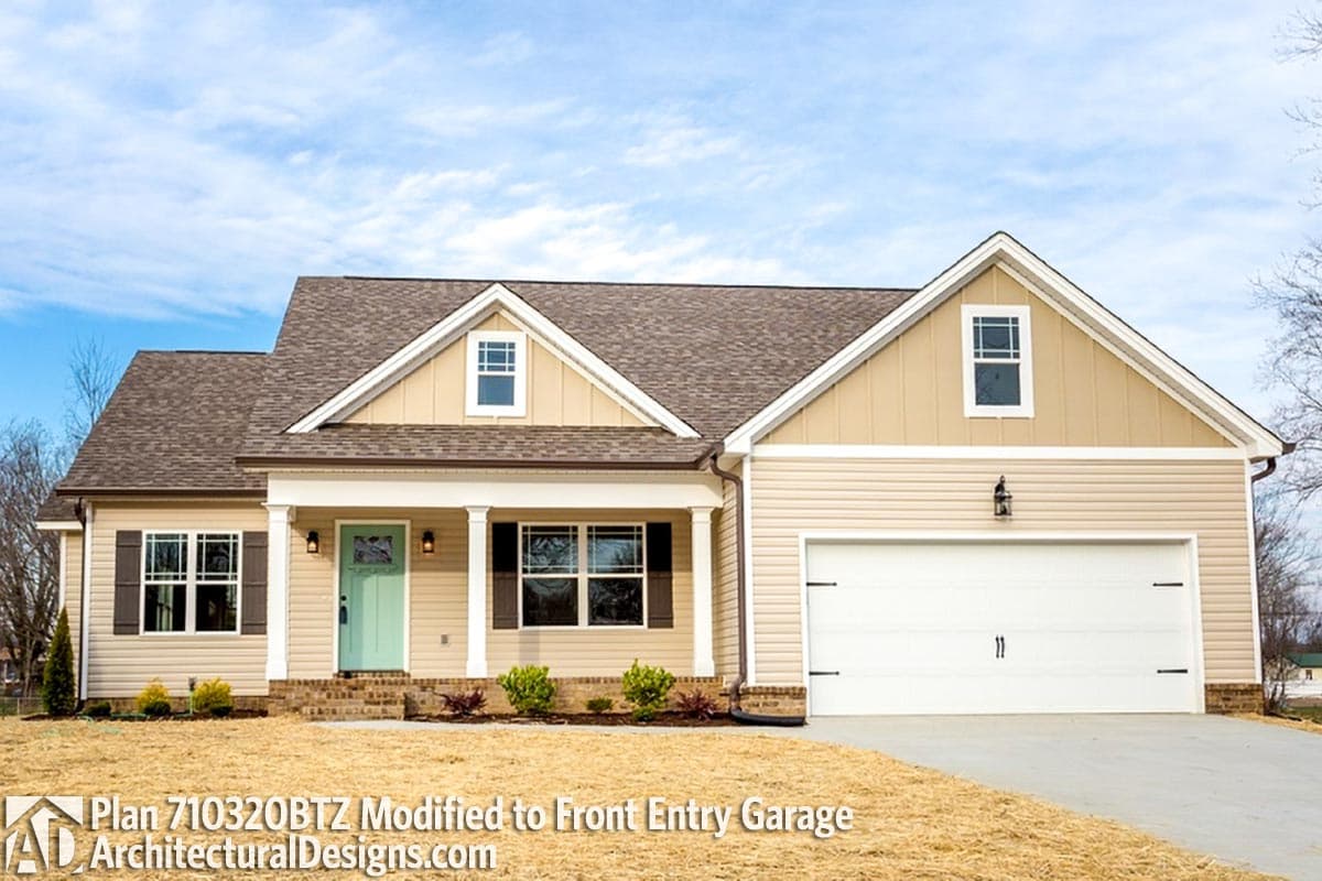 House plan exterior: Ranch style, one story, with front porch, gables, dormer window, and front-entry garage.