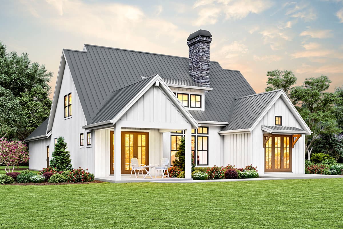 Modern Farmhouse house plan exterior with white vertical siding, metal gable roofs, stone chimney, and covered front porch.