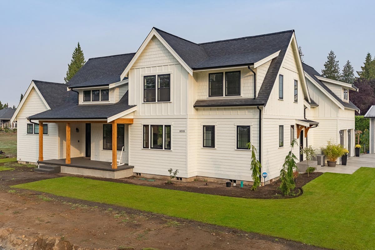 House plan exterior featuring Modern Farmhouse style with two stories, gabled roof, covered porch, and board-and-batten siding.