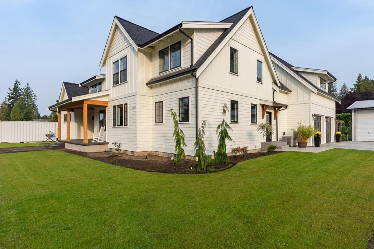 Modern Farmhouse style house plan exterior with a covered porch, gables, and a two-car garage.