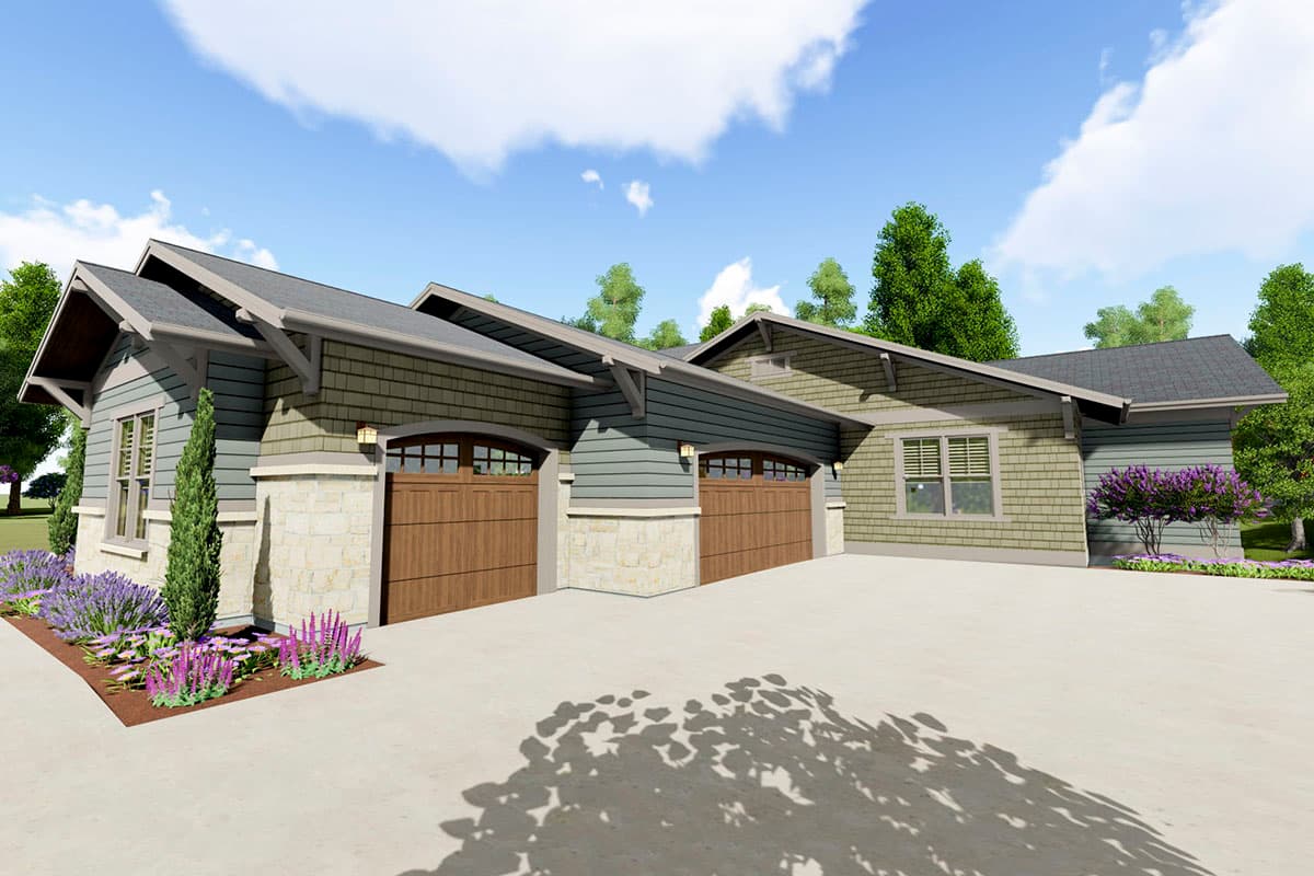 House plan exterior with three garage bays, stone foundation, shingle siding, and prominent gabled rooflines.