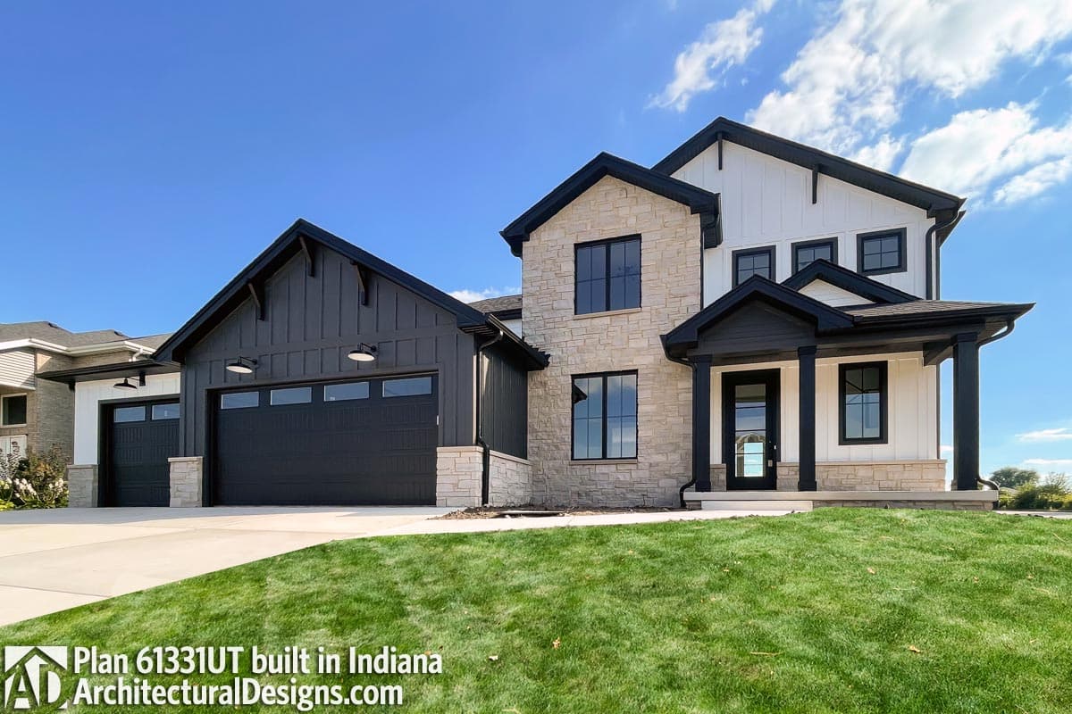 Modern Farmhouse house plan exterior with stone and board and batten siding, gable roof, and attached garage.