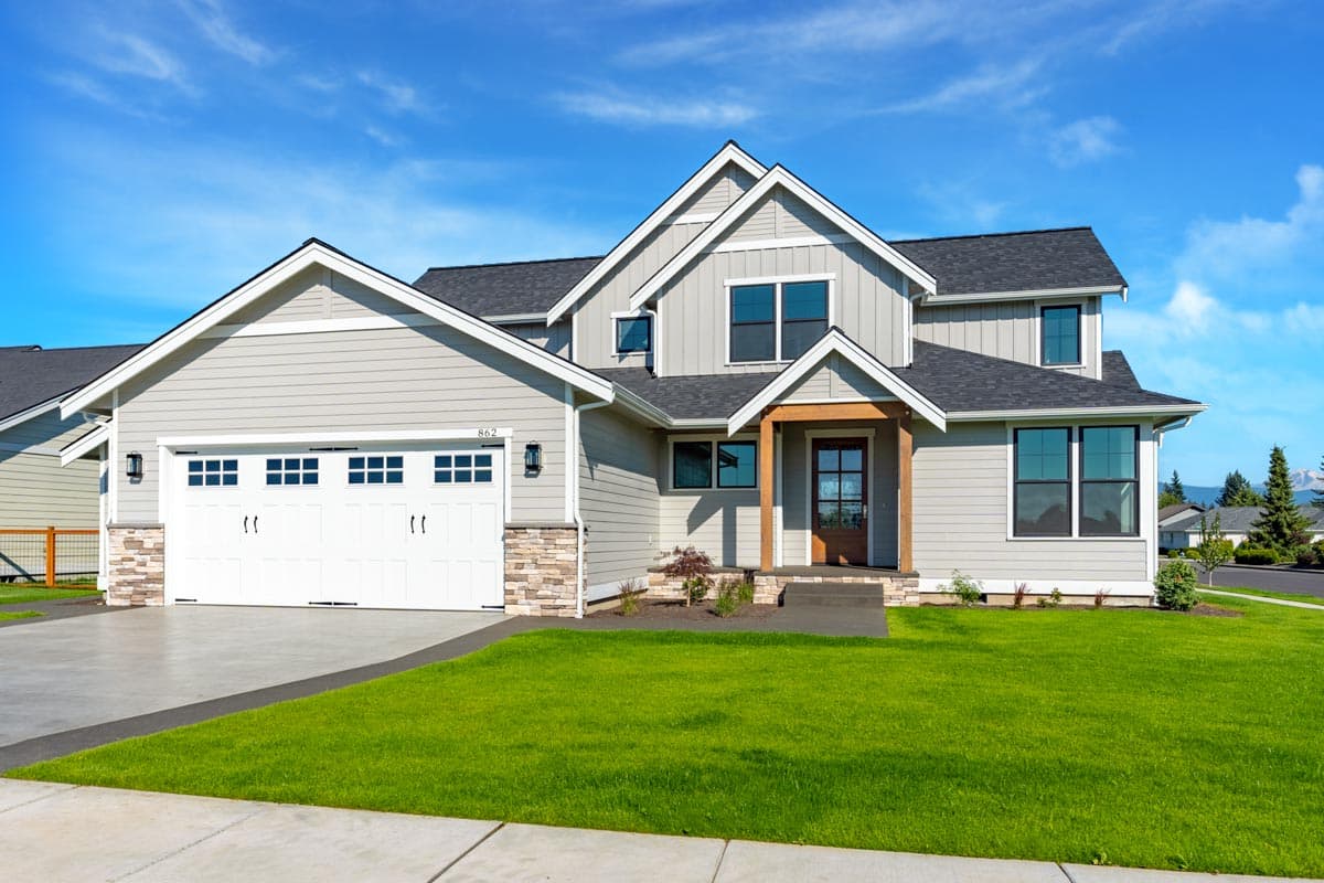 House plan exterior featuring a two-story Modern Farmhouse design with a side-entry garage, gabled dormers, and a covered entry.