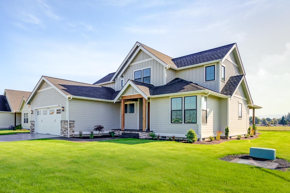 Modern Farmhouse house plan exterior with a two-car garage, prominent gables, and a covered entryway.