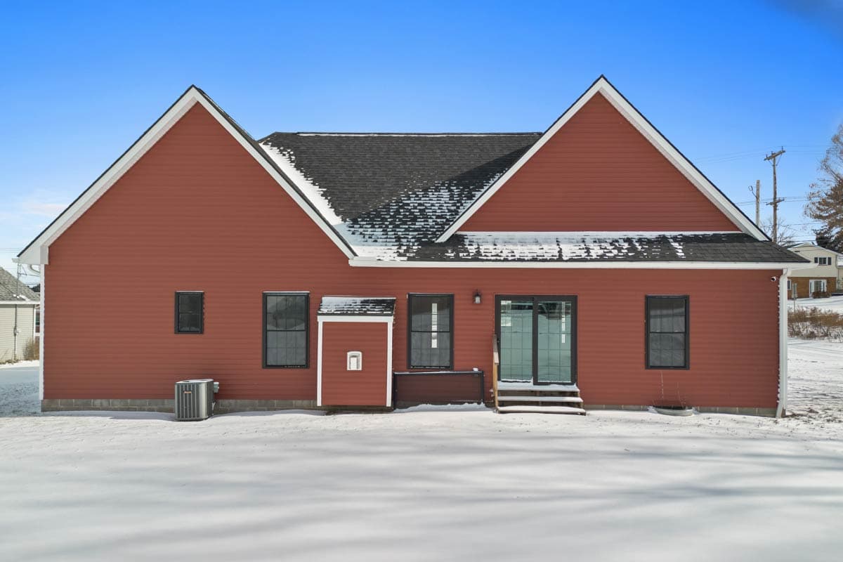 House plan exterior, two stories with prominent gables, dark windows, and sliding glass doors.