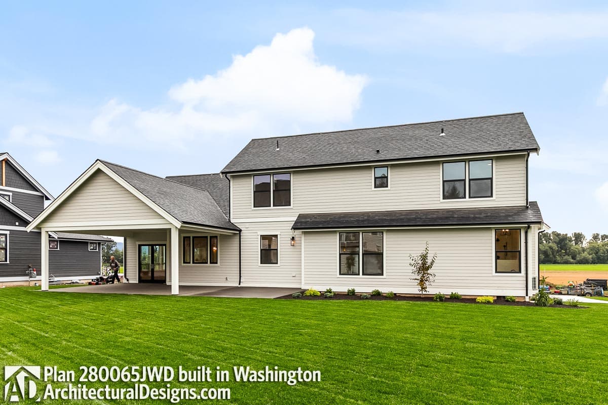 House plan exterior: Two-story Modern Farmhouse with a covered carport, multiple gables, and numerous windows.