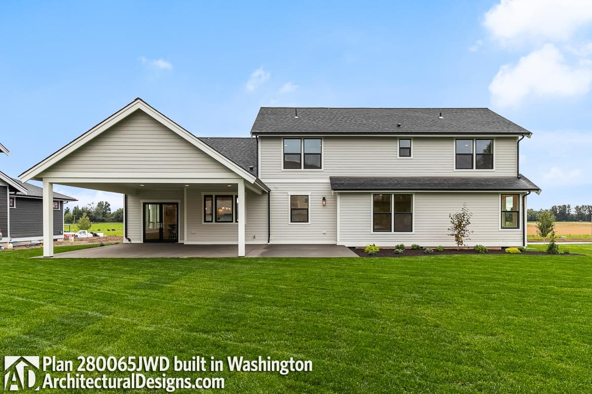 House plan exterior: two-story dwelling with a prominent covered patio, multiple gables, and horizontal siding.