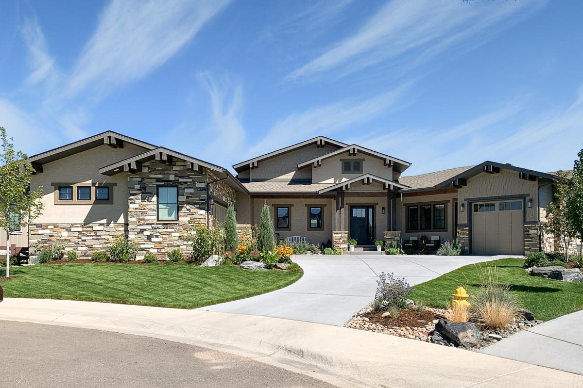 House plan exterior. Craftsman style, single-story home with stone and stucco siding, gabled roof, and attached garage. Includes covered front porch.