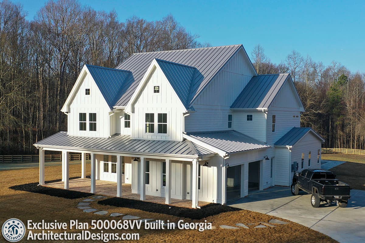 Modern Farmhouse house plan exterior with a wraparound porch, gabled dormers, and a side-entry garage.