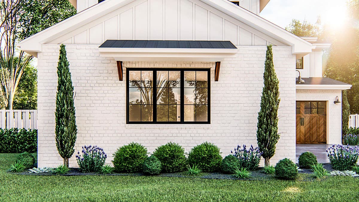 Modern Farmhouse house plan exterior with white brick, gabled roofline, large grid window, and wood-accented awning.