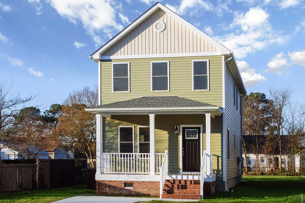 House plan exterior. Two-story house with a front porch, gabled roof, and vertical siding on the upper level.