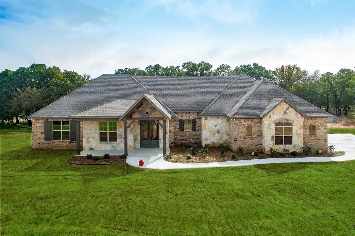 House plan exterior with stone and brick facade, gabled roof, and covered porch with exposed beams. Single-story, with shutters.