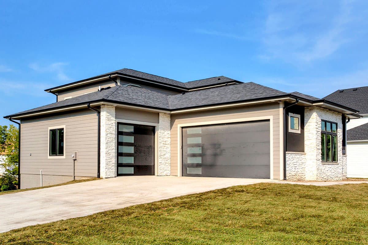 Modern house plan exterior with horizontal siding, stone accents, and two glass garage doors.