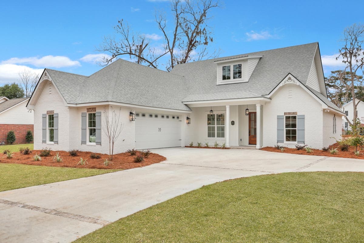House plan exterior: Modern Farmhouse style, one story, white brick, gabled dormer, covered entry porch, side-facing garage.