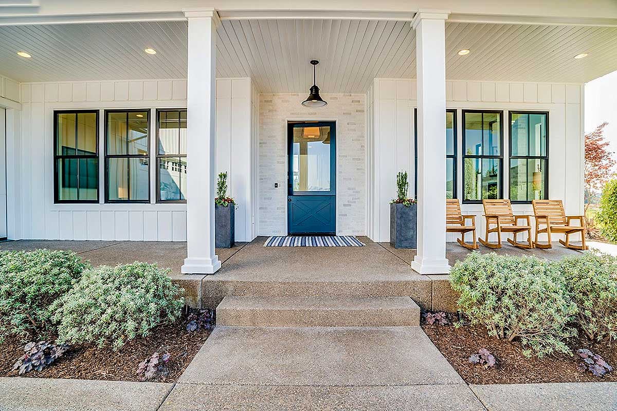House plan exterior: Modern Farmhouse style, covered porch with white columns, board and batten siding, dark-framed windows, and a blue Dutch door.