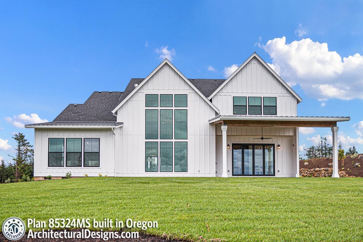 Modern Farmhouse house plan exterior with vertical siding, prominent gables, large window arrays, and covered patio.