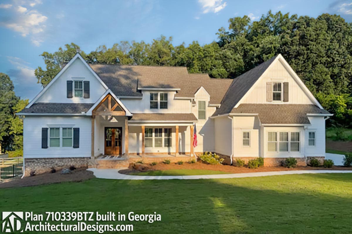 House plan exterior with a Modern Farmhouse style, two stories, covered porch, gables, and wood beam accents.