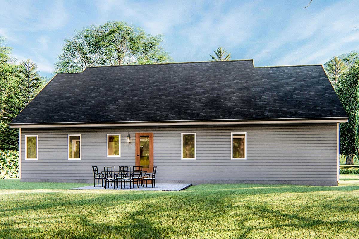 House plan exterior, single story with gray siding, multiple windows, a patio with outdoor seating, and a dark roof.