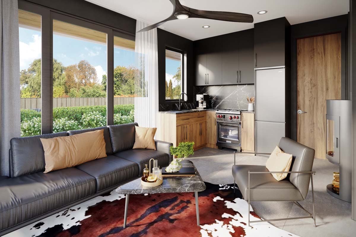 Modern living area with black leather sofa, L-shaped kitchen with wood cabinets, and stainless steel appliances. Large windows overlook garden.