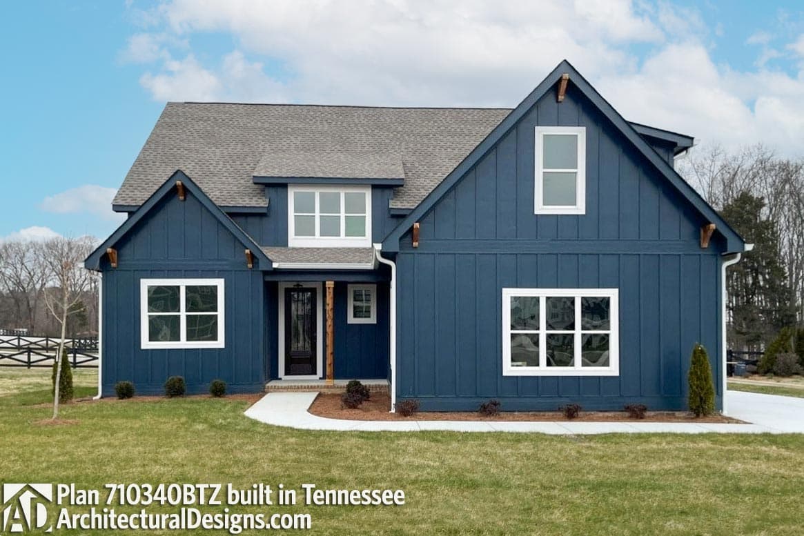 Modern Farmhouse house plan exterior with board and batten siding, prominent gables, and a covered entry with wood posts.
