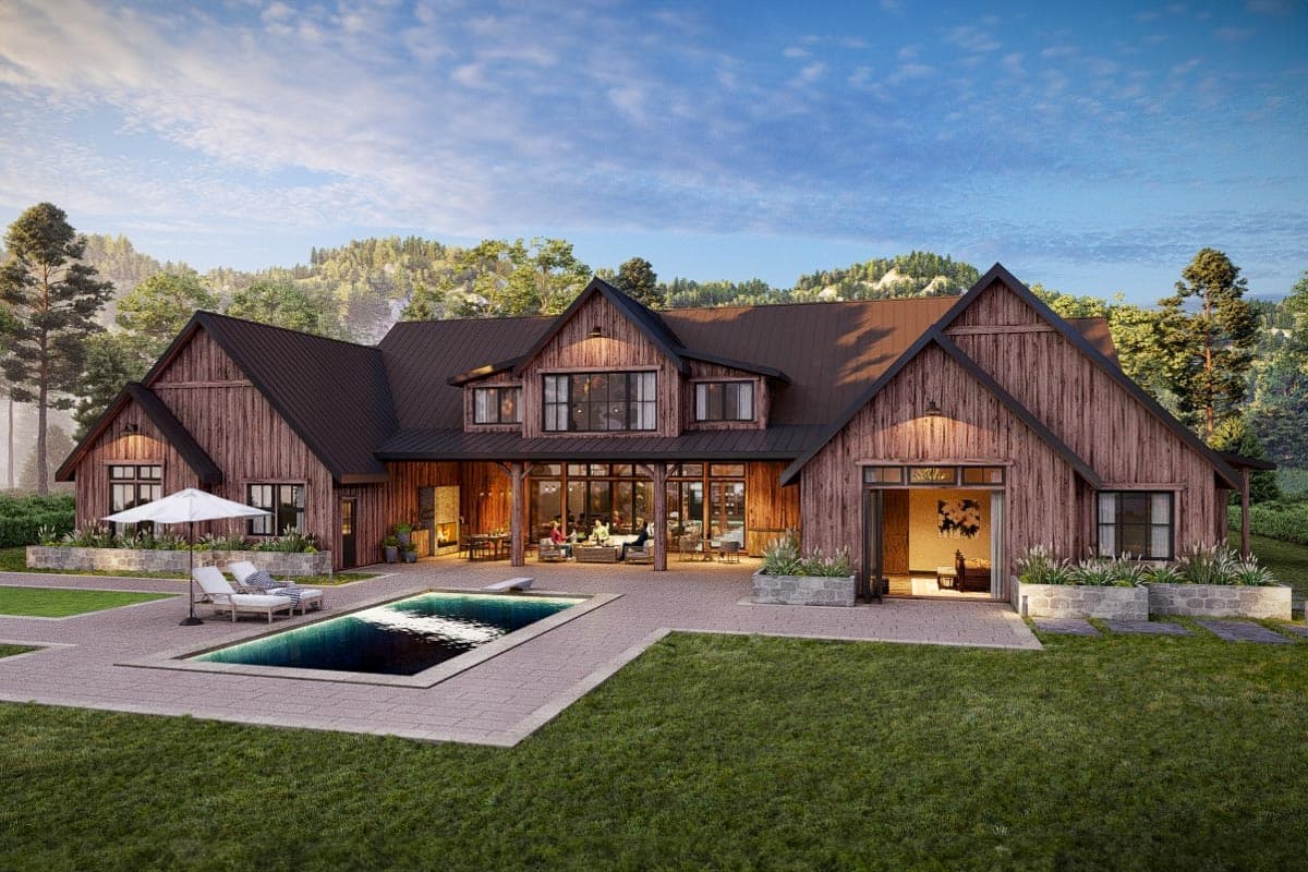 Modern Farmhouse style house plan exterior with wood siding, gabled rooflines, covered patio with outdoor fireplace, and swimming pool.