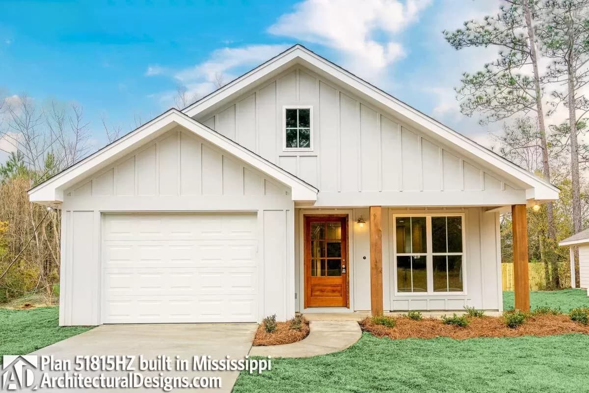 A 3-bedroom ranch house with a white exterior, wooden accents, and a garage. Built in Mississippi.