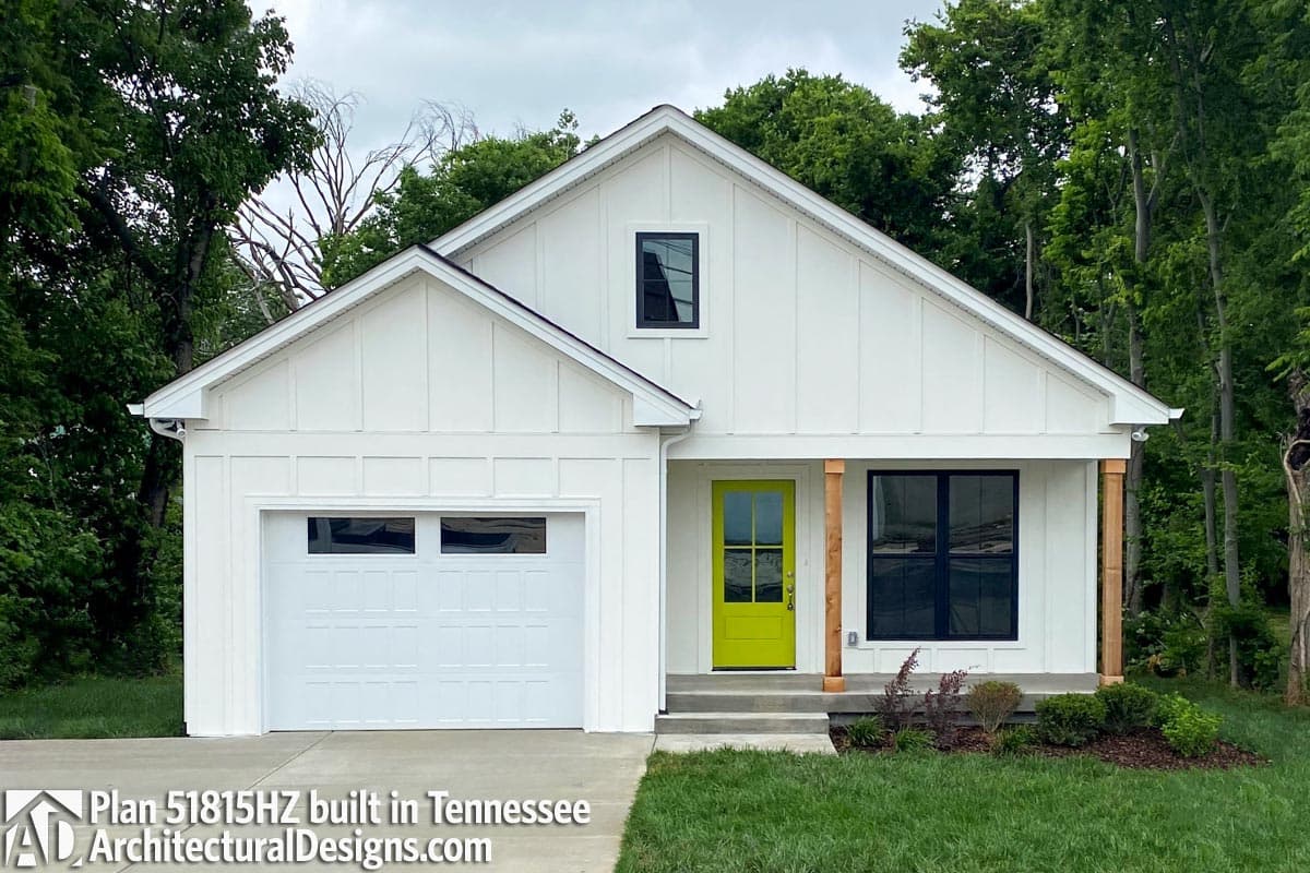 Modern white ranch house with a lime green front door, a small window, and black window frames. Built in Tennessee.