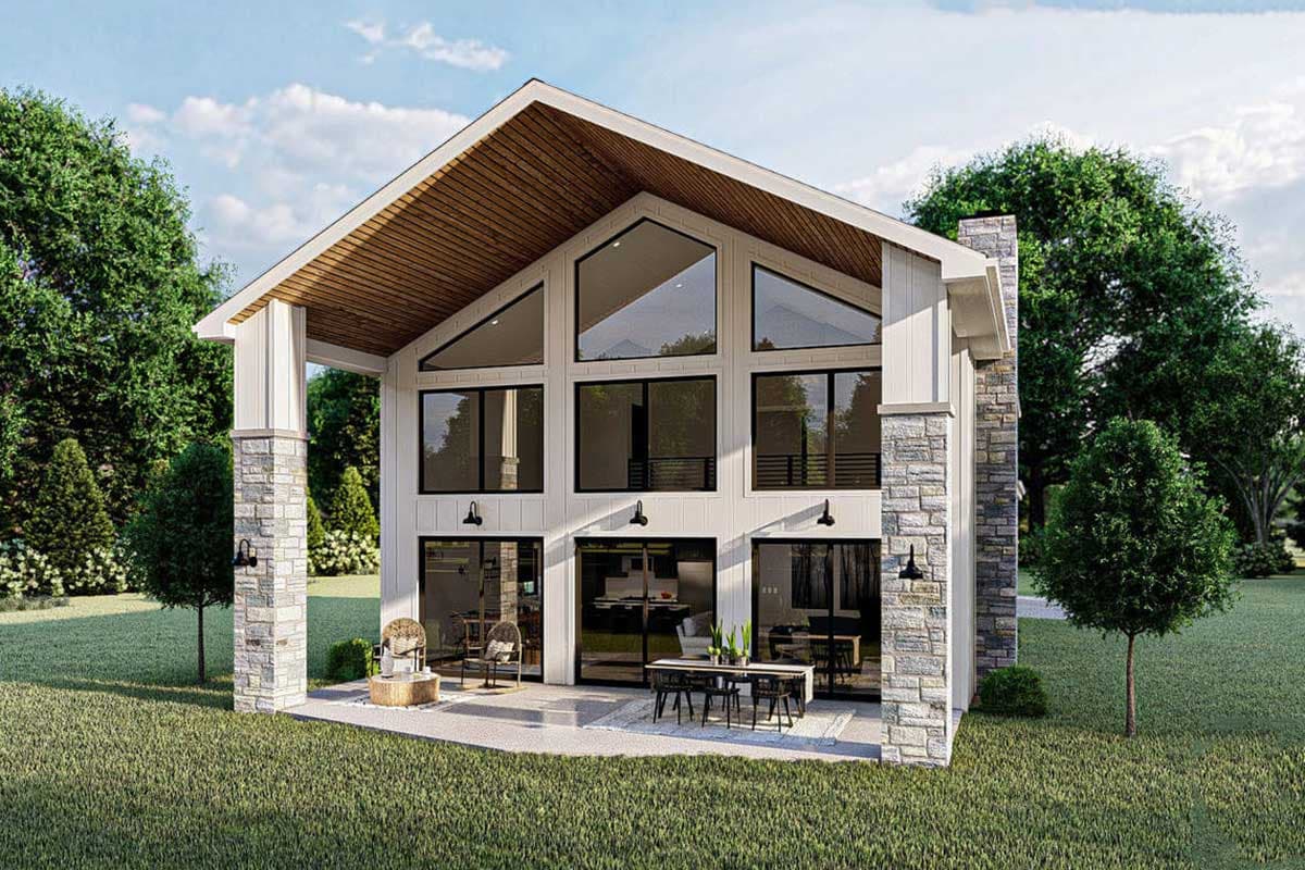 House plan exterior: Modern style, two stories, large gabled roof, stone accents, and expansive windows.