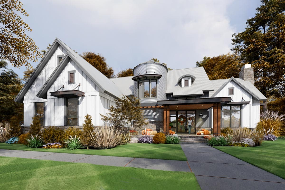 Modern Farmhouse style house plan exterior with metal roof, prominent gables, stone accents, and a silo-shaped turret.