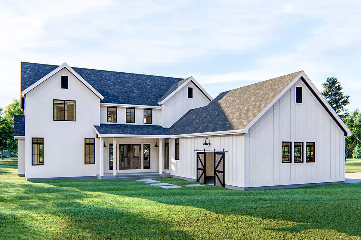 Modern Farmhouse house plan exterior with white siding, gables, covered porch and barn-style garage door.