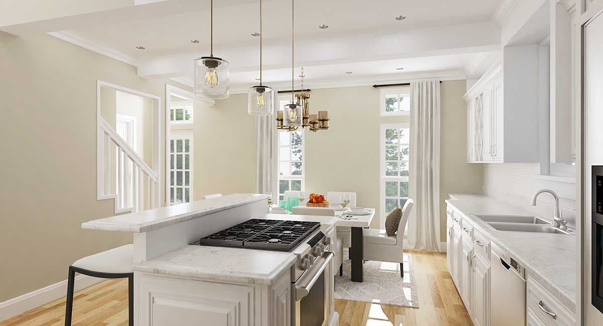 Open-concept kitchen and dining area with island, gas range, white cabinetry, and dining table.