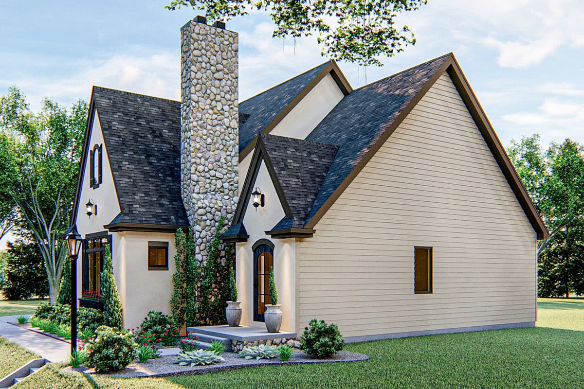 House plan exterior featuring a stone chimney, arched entry, gables, and multi-level dark roof.