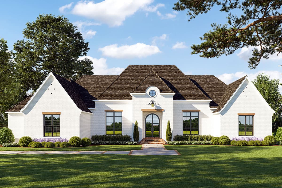 House plan exterior: white brick, arched entry, gables, central dormer with circular window, multi-story roof.