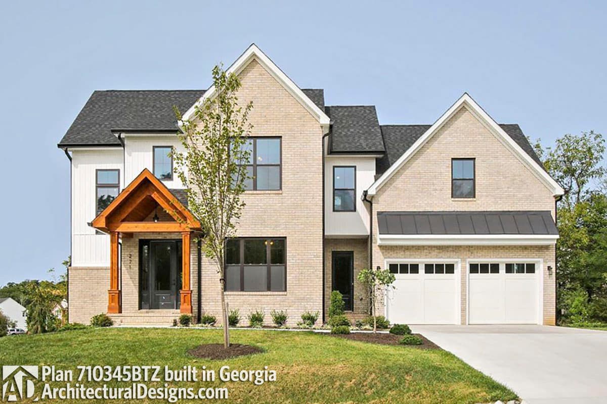 House plan exterior of two-story home with brick and vertical siding, gabled roof, wood-frame porch, and a three-car garage.