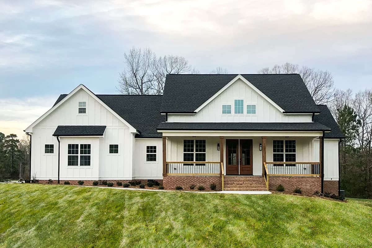 Modern Farmhouse house plan exterior with gabled dormers, board and batten siding, and covered front porch with wood columns.