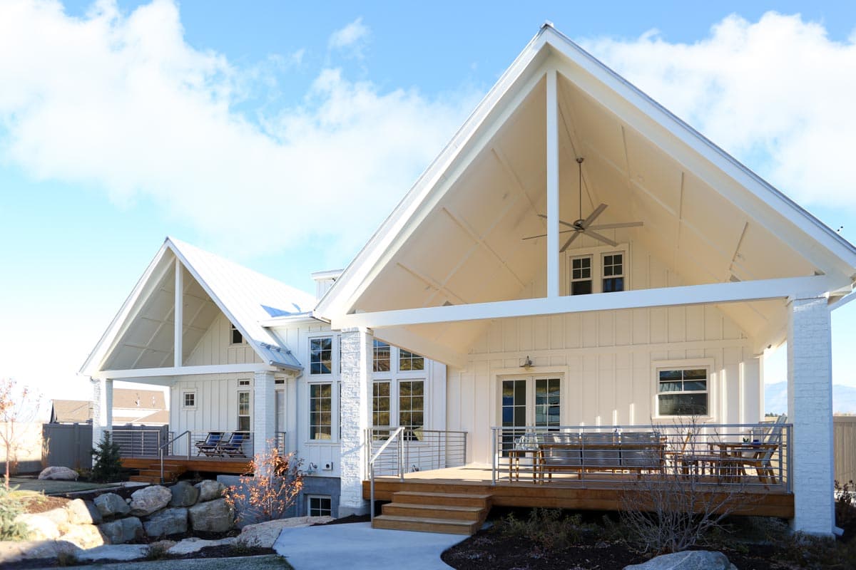 Modern Farmhouse house plan exterior with gable rooflines, exposed rafter tails, and a covered porch with ceiling fan.