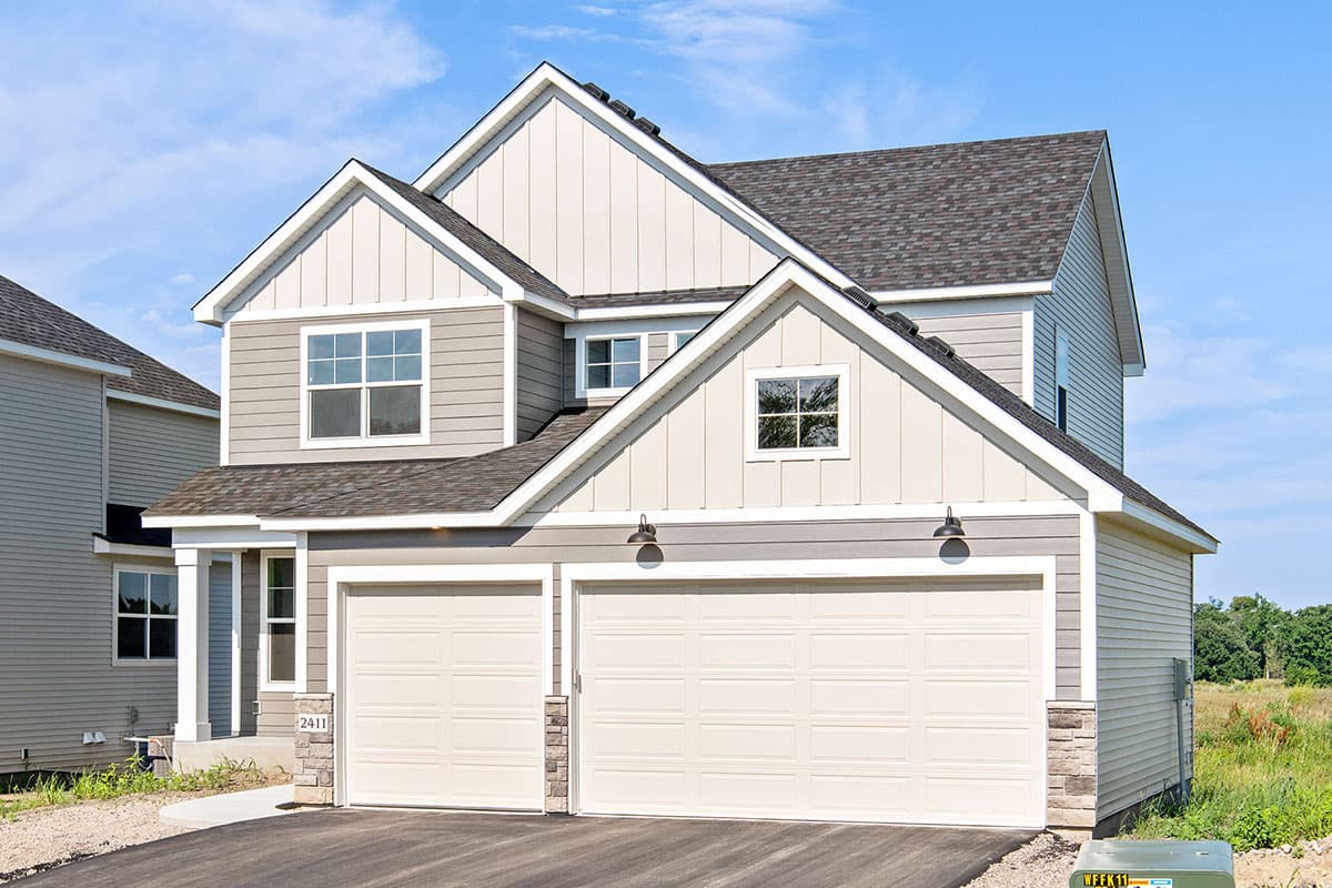 House plan exterior featuring a two-story Modern Farmhouse design with a prominent gable, three-car garage, and board-and-batten siding.