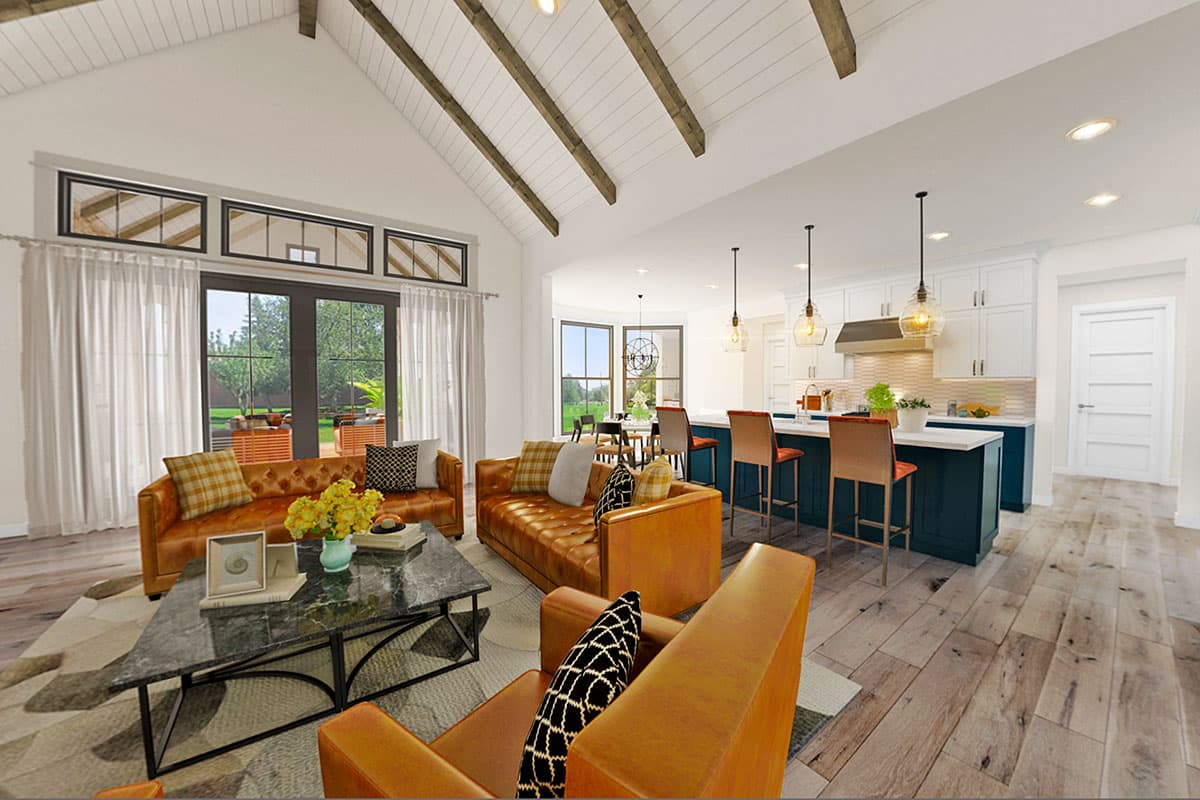 Open concept living area with vaulted ceiling, exposed beams, and kitchen island with bar seating.