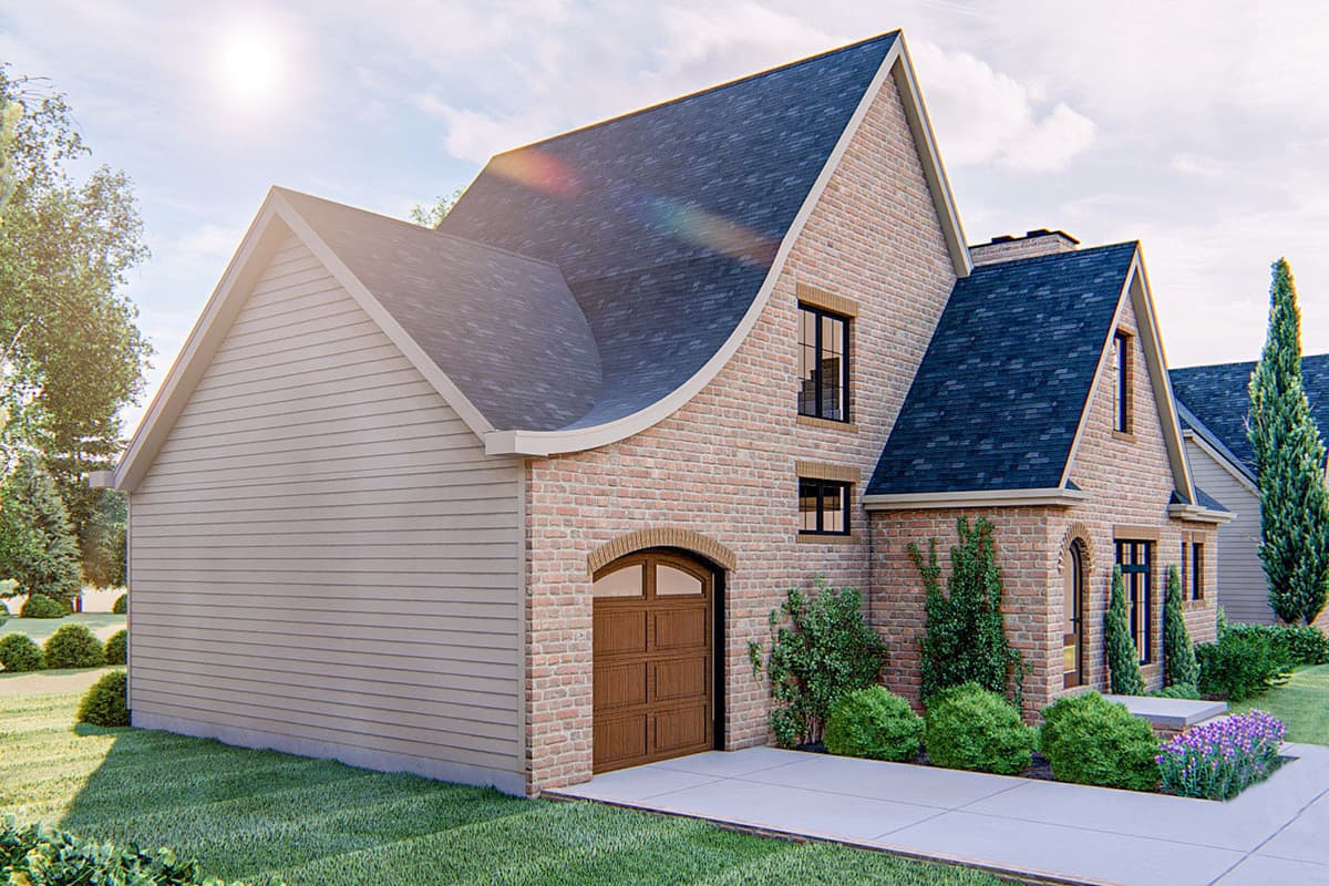 House plan exterior featuring brick and siding, a curved roofline, and an arched garage door.