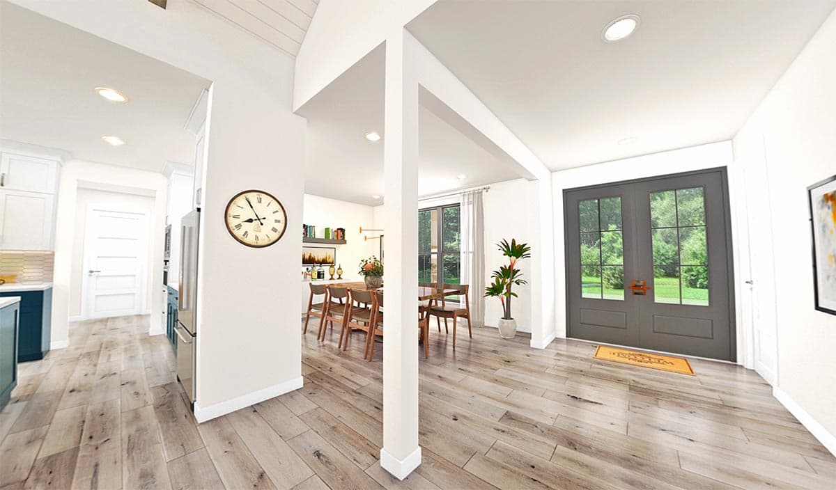 Interior view of a house plan showing a kitchen, dining area, and entrance with double doors. Vaulted ceiling visible.