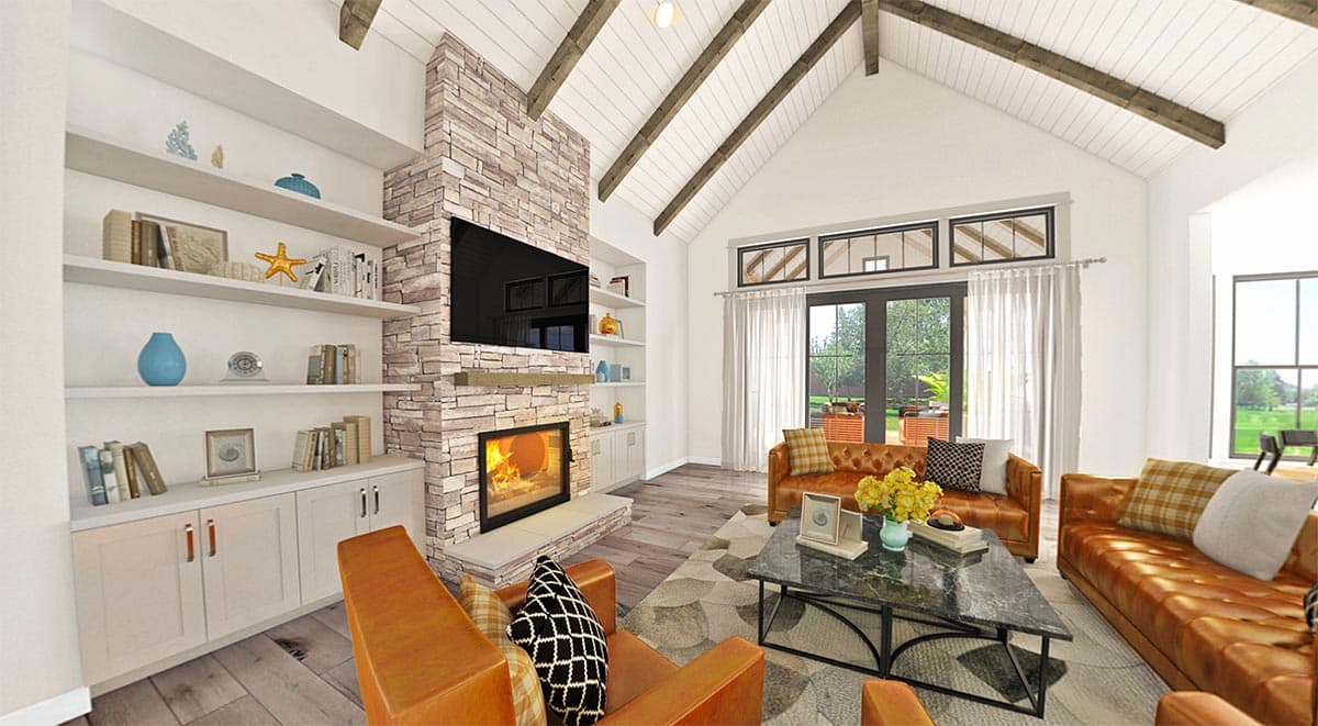 Great room with stone fireplace, vaulted beamed ceiling, built-in shelving, and large windows overlooking yard.