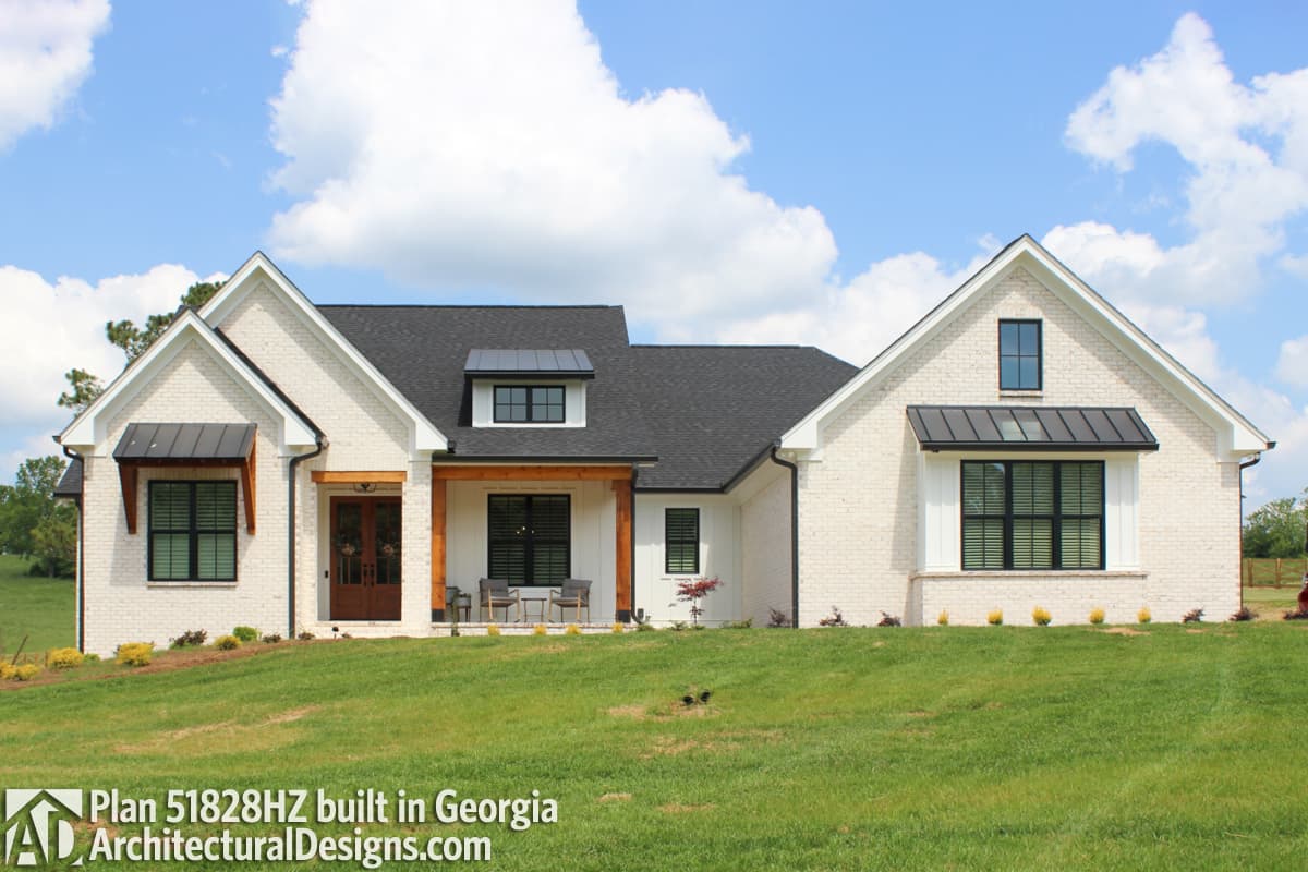 House plan exterior: Modern Farmhouse style, one-story with gables, covered entry, and metal awnings over windows.