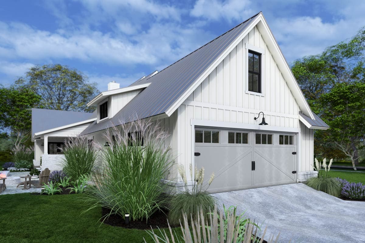 A modern, white farmhouse-style home with a gray roof and garage. Tall ornamental grasses and manicured landscaping are in the foreground.