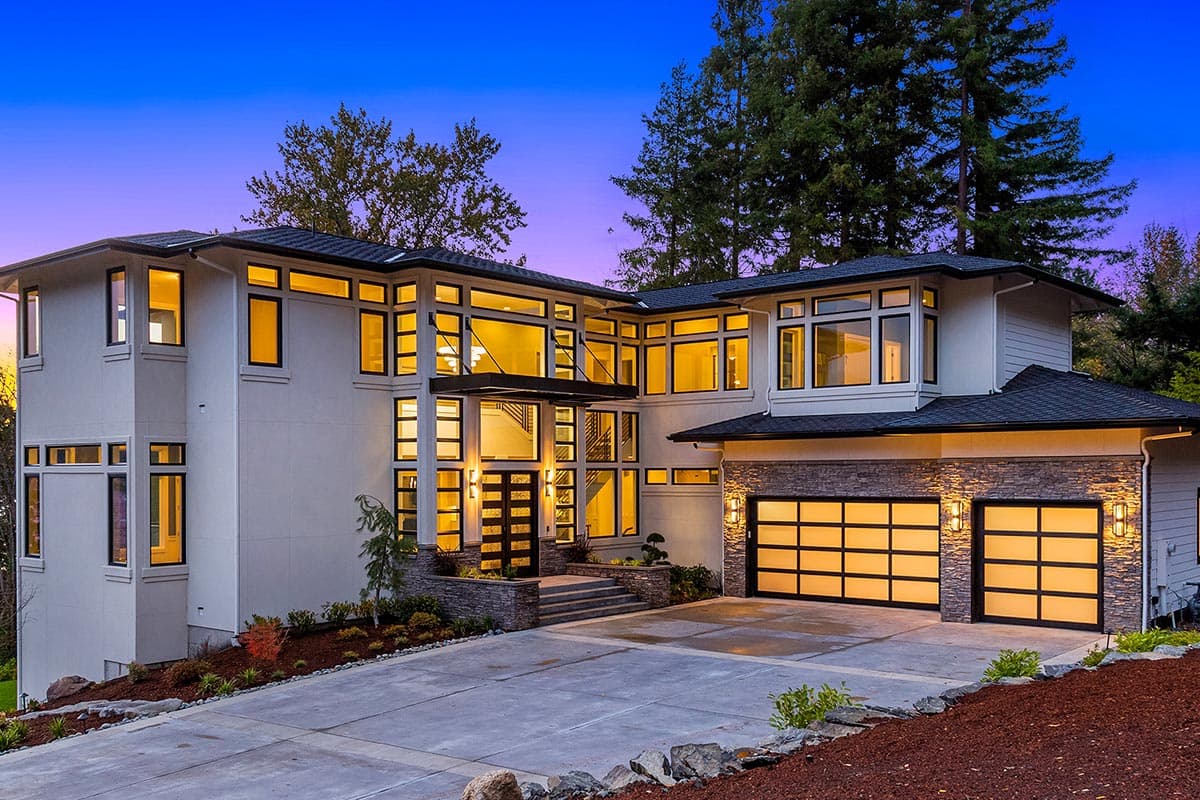 House plan exterior. Modern style, two-story home with flat rooflines, large windows, and a multi-car garage with glass-panel doors.