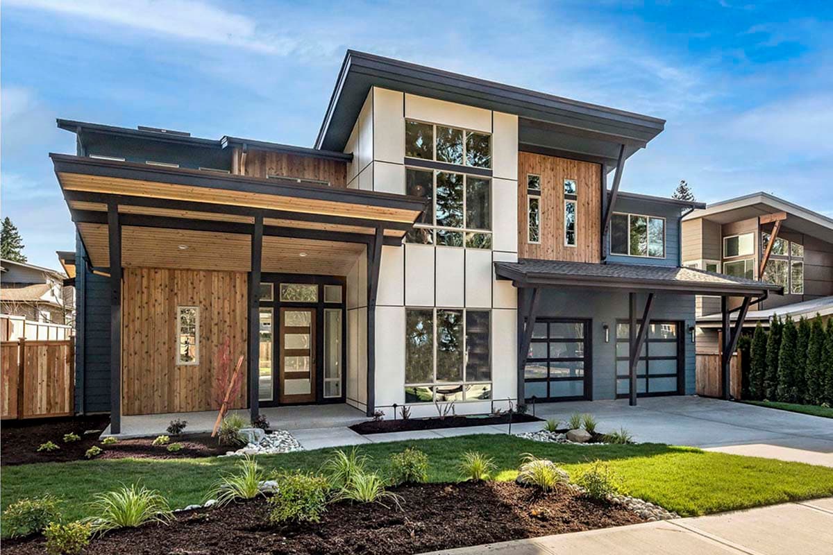 Modern house plan exterior with two stories. Features include a covered entry, flat rooflines, and a glass-paneled garage door.