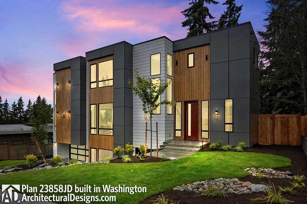 Modern house plan exterior with multi-story wood and gray paneling, tall windows, and a red front door.