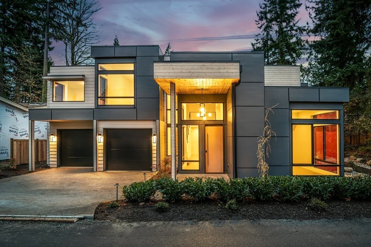 House plan exterior. Modern style, two-story home with flat rooflines. Features include a covered entry, two-car garage, and large windows.