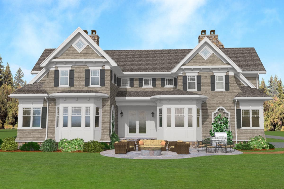 House plan exterior: Two-story residence with shingle siding, bay windows, prominent gables, and stone chimneys.
