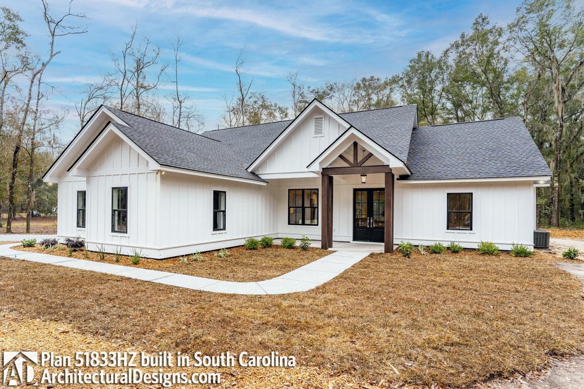 Modern Farmhouse house plan exterior with board and batten siding, a gabled roof, and a covered entry with wood beams.