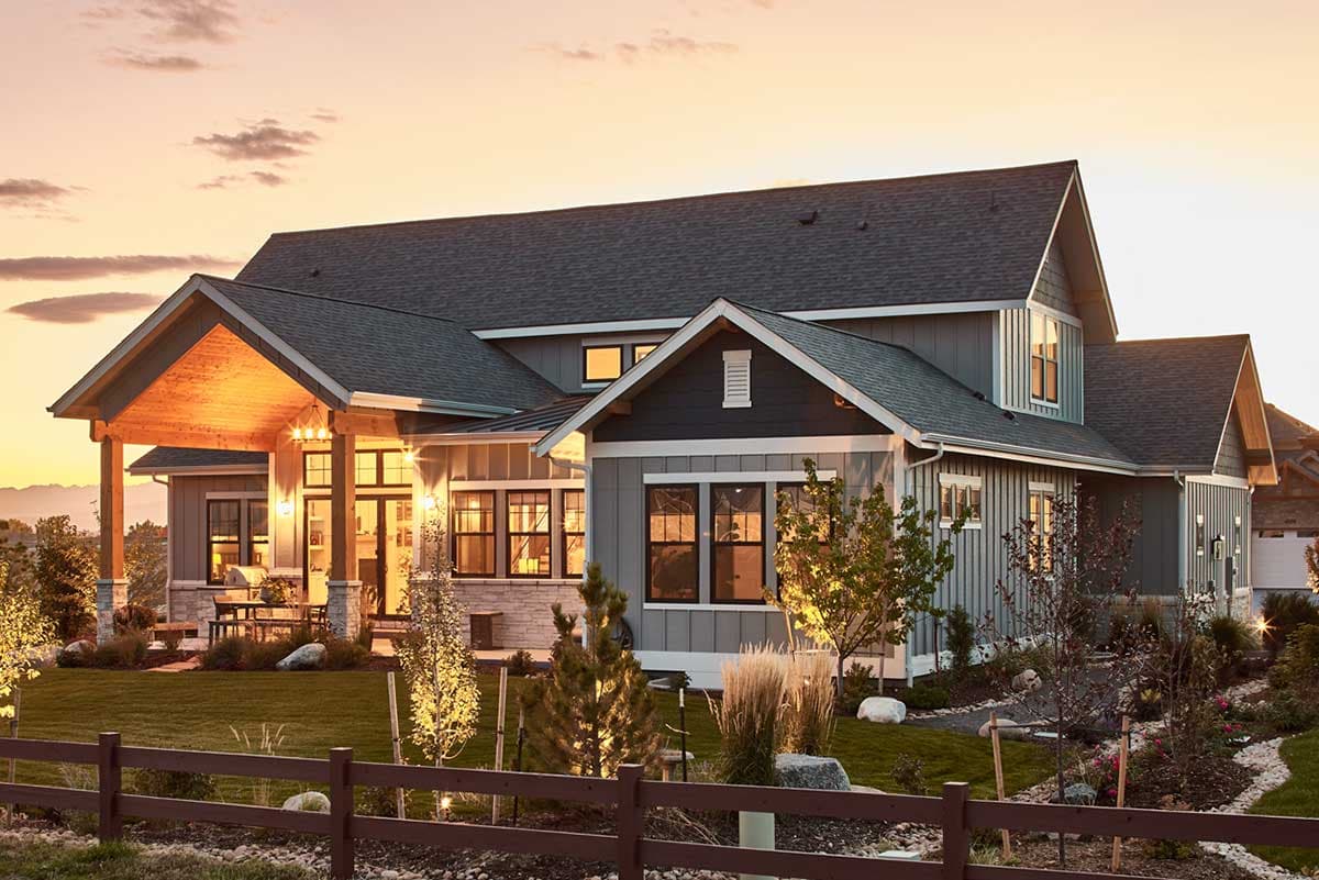 House plan exterior: Modern Farmhouse style with covered porch, stone accents, multiple gables, and board and batten siding.
